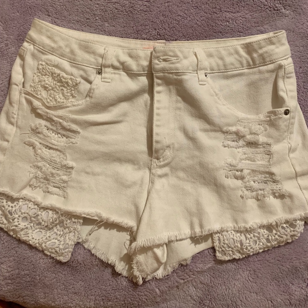 Distressed shorts with crochet pockets.
